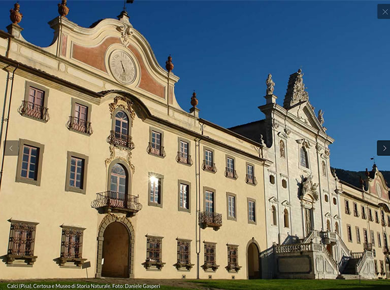 Historic Charterhouse of Calci in Pisa, featuring ornate architecture and intricate details under a clear blue sky.